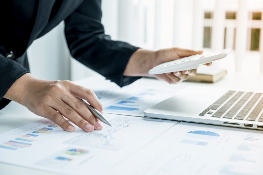 Businesswoman analysis the chart with laptop at the office for setting challenging business goals