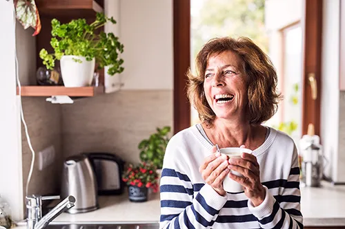 Stock photo of lady smiling Holding a mug