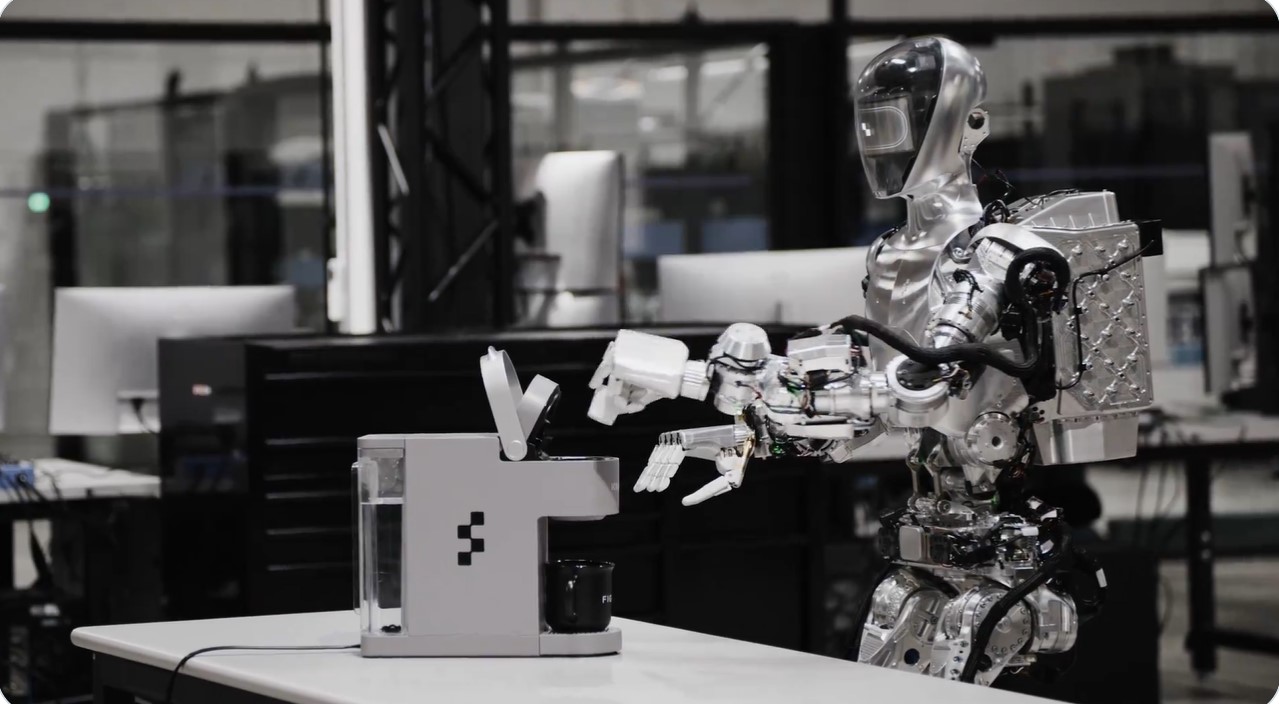 A man watching a robot make coffee