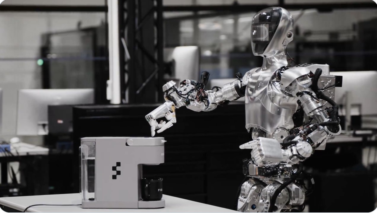 A man watching a robot make coffee