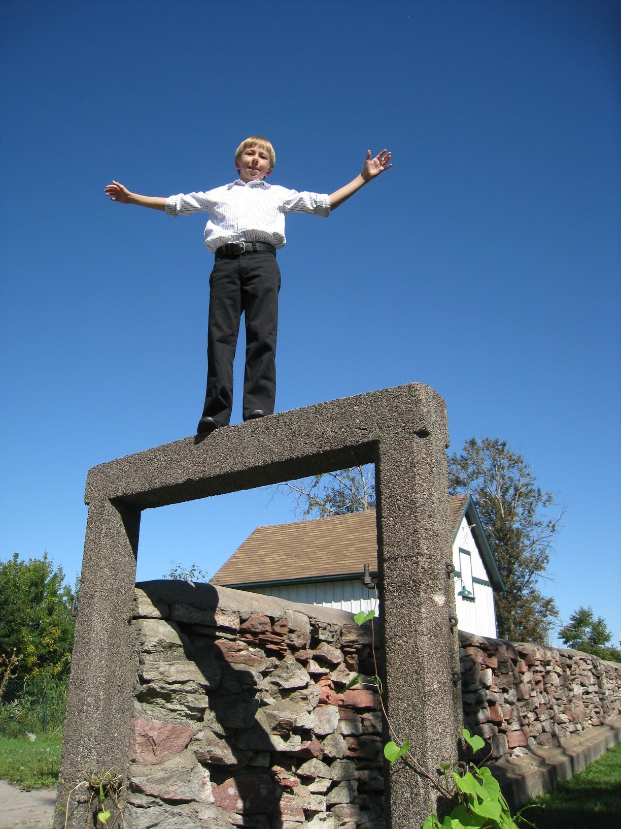 Glen's son (Kian) standing on top of an archway