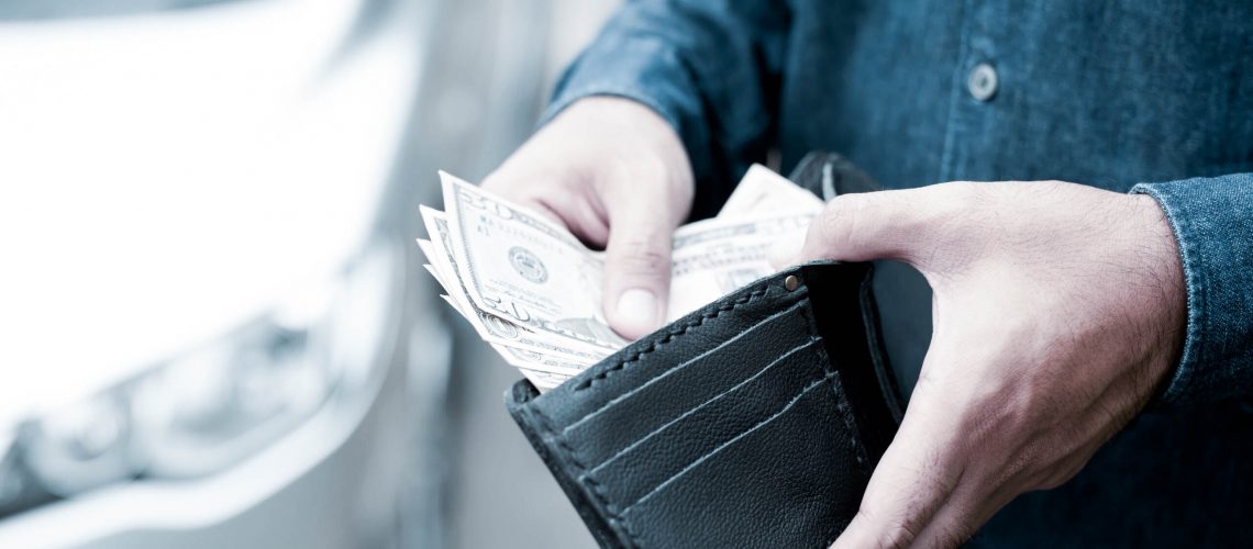 Businessman Person holding a wallet in the hands of take money o