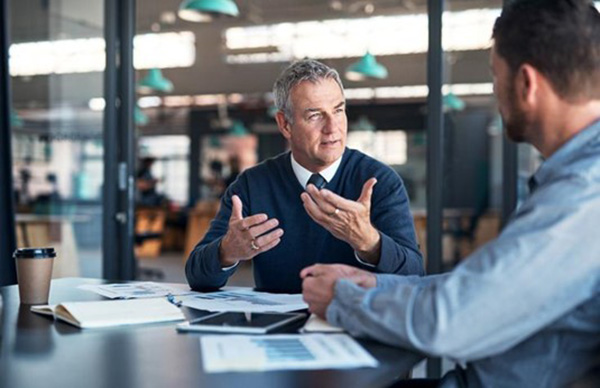 two men sharing there thoughts in a office