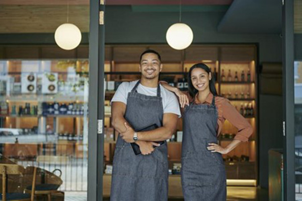 two bartenders standing in a door way