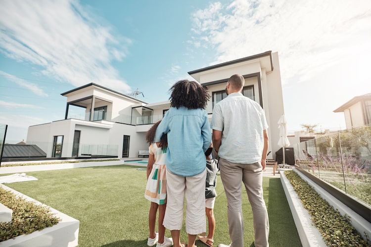 black family standing outside of a property