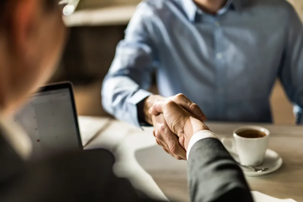 Portfolio manager shaking hands with Client