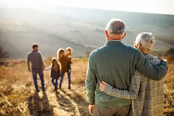 parents looking at children holding grandchildren